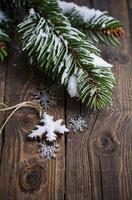 Snowflake Ornaments with Fir Branch on Rustic Wooden Surface photo
