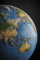 Exploring Asia and Australia Globe Model Close-up Showing Earth's Continents photo