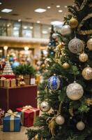 Decorated Christmas Tree with Ornaments and Gift Boxes in Shopping Mall photo