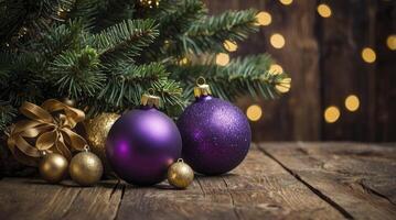 Christmas Ornaments on Wooden Table with Bokeh Lights and Evergreen Boughs photo
