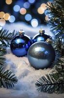 Blue christmas balls on snow background photo