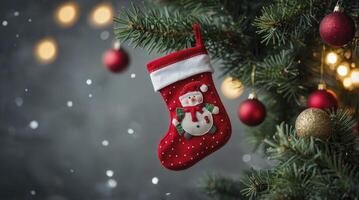 Christmas Stocking Hanging on Tree with Ornaments and Snowflakes Falling photo