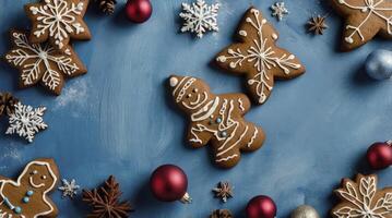 Festive Gingerbread Cookies and Christmas Decorations on Blue Background photo