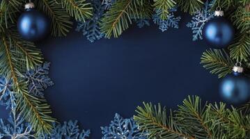 Christmas Blue Ornament and Fir Branch on Dark Blue Background photo