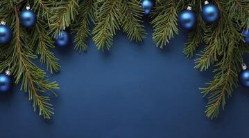 Festive Blue Christmas Ornaments and Evergreen Branches on Dark Background photo
