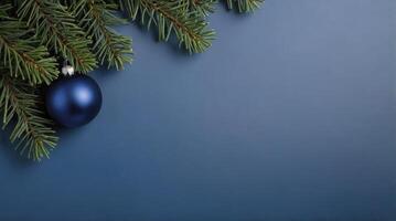 Christmas Ornament and Evergreen Branch on Blue Background for Festive Season photo