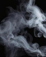 Wispy White Smoke Flowing Against Black Background for Abstract Design photo