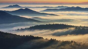 Foggy Mountain Landscape at Sunrise with Layered Ridges and Misty Valleys photo