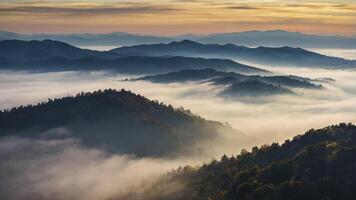 Layered Mountain Landscape with Morning Fog Rolling Through Valleys at Sunrise photo