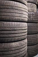 Storage of car tires in a stack, background with neatly arranged car wheels photo