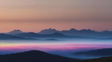 Fog Shrouded Mountain Range at Sunrise with Beautiful Pink Hues photo