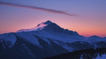 Snowy Mountain Peaks at Sunset with Colorful Sky and Clouds photo