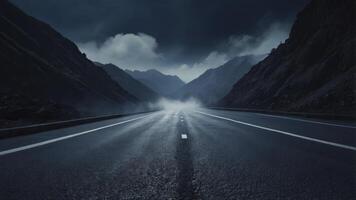 Driving Along Scenic Mountain Road with Low Clouds and Misty Atmosphere photo