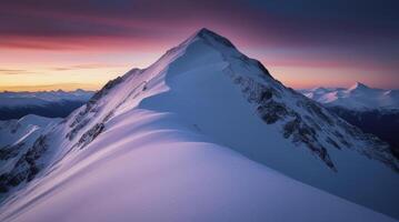 Snowy Mountain Peak at Dusk with Pink Sky in Winter Landscape photo