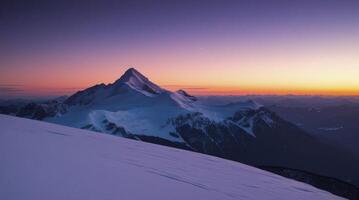Majestic Mountain Peak at Sunset with Snow Covered Landscape and Sky photo