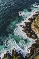 Ocean Waves Crashing on Rocky Coastline Seen From Above in Australia photo