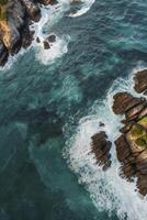Aerial View of Waves Crashing on Rocky Coastline Azure Ocean Water photo