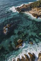 Aerial view of the ocean and rocky coastline in the pacific ocean photo