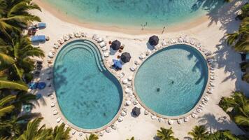 Aerial View of Luxury Resort Pools with Palm Trees and Sandy Beach photo