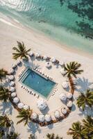 Aerial View of Tropical Resort Pool with Beachfront and Palm Trees photo