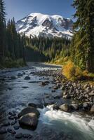 Flowing River Below Snow Capped Mountain and Forest Landscape photo
