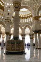 Interior View of Grand Mosque with Intricate Designs and Reflections photo