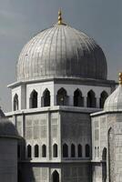 Detailed Dome Structure of Ornate Islamic Mosque Against Overcast Sky photo