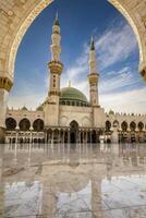 Viewing Quba Mosque Through Archway with Reflection in Medina Saudi Arabia photo