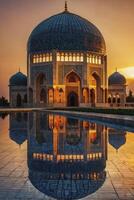 Reflecting Mosque Architecture at Sunset with Golden Sky and Water photo