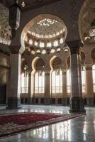 Exploring Intricate Mosque Interior with Archways, Columns and Marble Floor photo