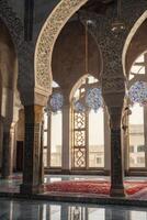 Elaborate Islamic Architecture with Arches, Columns and Red Carpet photo
