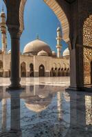 Reflecting Mosque Courtyard Architecture with Dome and Minarets Under Clear Blue Sky photo