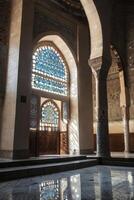 Exploring Ornate Mosque Interior with Stained Glass Window and Reflected Light photo