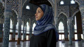 Woman in Hijab in Islamic Architecture Interior Posing in Mosque photo