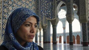 Woman in Hijab at Mosque with Intricate Blue Tile Design Interior photo