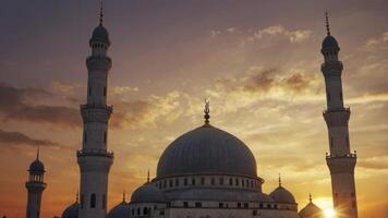Mosque Architecture at Sunset with Tower Minarets and Dramatic Sky photo