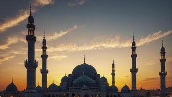 Stunning Mosque Silhouette at Sunset with Minarets and Golden Sky photo