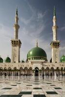 Prophet's Mosque in Medina Featuring Green Dome and Minarets Architecture photo