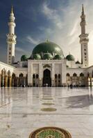 Visiting the Prophet's Mosque in Medina with Green Dome and Minarets photo