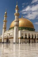 Quba Mosque Medina Saudi Arabia with Golden Dome and Minarets photo