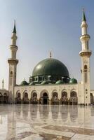 Medina Mosque View with Reflective Marble Ground and Green Dome photo