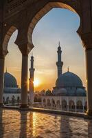 Mosque Architecture at Sunset Framed by Arches with Golden Reflections photo
