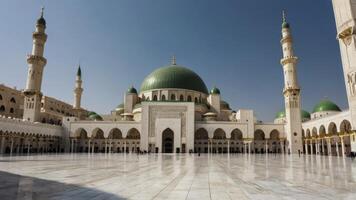 Grand Mosque Architecture with Green Dome and Minarets Under Clear Blue Sky photo