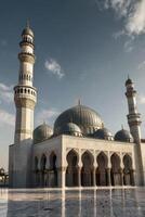 Magnificent Mosque Architecture with Minarets and Dome Against a Clear Sky photo