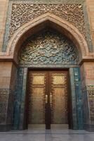 Elaborate Door with Archway and Blue Tile Details in Islamic Architecture photo