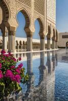 Ornate Mosque Architecture with Arches Reflecting in Water Pool and Flowers photo