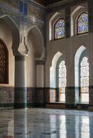 Exploring Historic Mosque Interior with Arches, Columns, and Stained Glass Windows photo