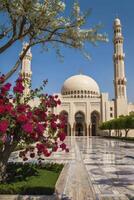 Visiting the Sultan Qaboos Grand Mosque with Blooming Flowers in Oman photo