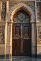 Elaborate Wooden Doorway with Intricate Gold Details and Stone Carvings photo