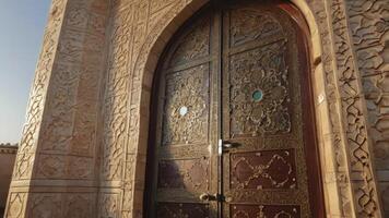 Elaborate Ancient Wooden Doorway with Intricate Carvings and Stone Archway photo
